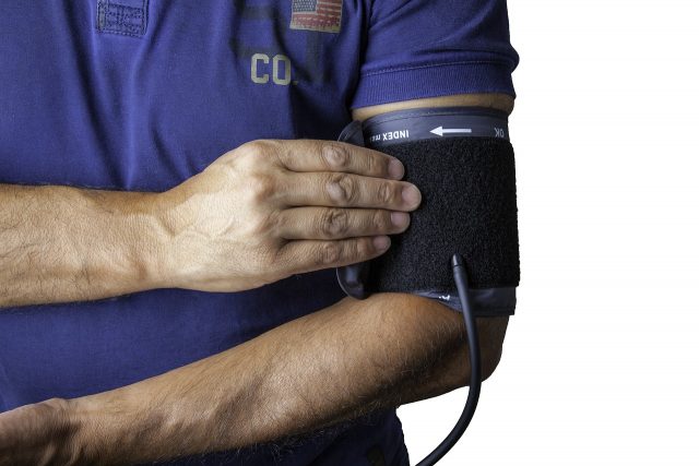 Man with blood pressure monitor